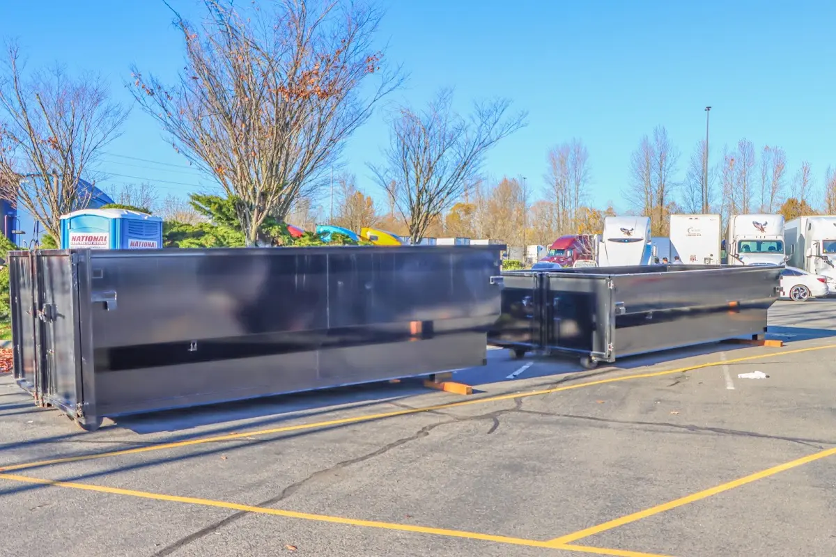 Professional dumpster rental service with roll-off container on residential driveway in Lealman